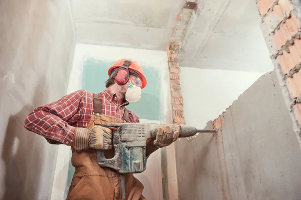 depositphotos_179991318-stock-photo-worker-with-demolition-hammer-breaking